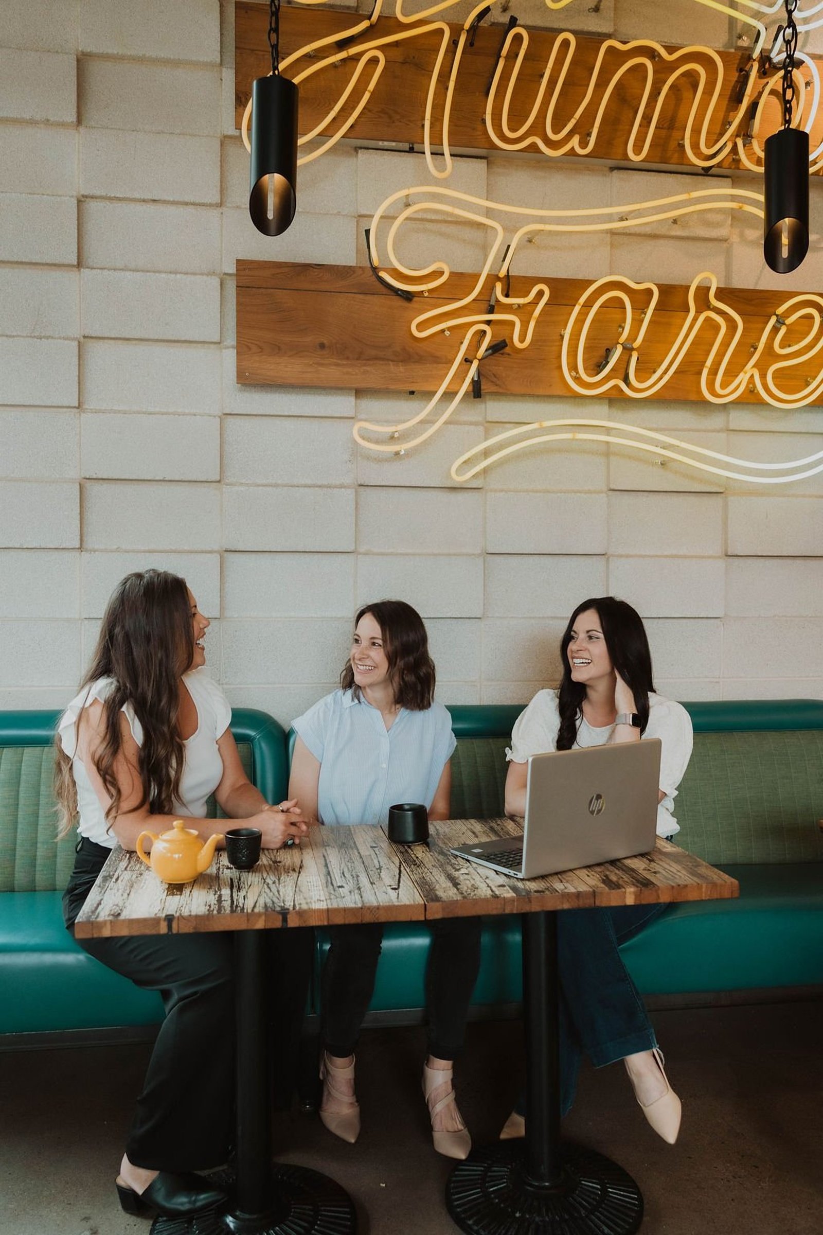 Three women talking together at a table